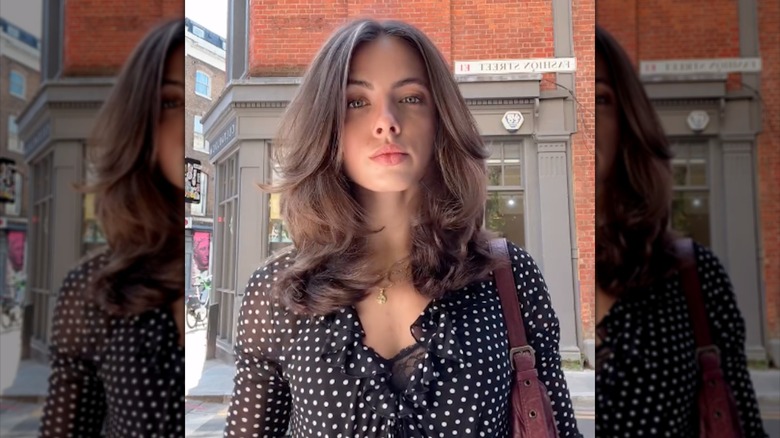 En kvinna med studsiga 90-talsinspirerade lager