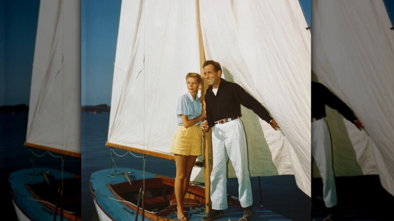 Lauren Bacall och Humphrey Bogart håller i en mast på en liten segelbåt