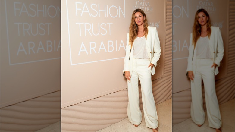 Gisele Bündchen poserar framför en skylt för Fashion Trust Arabia