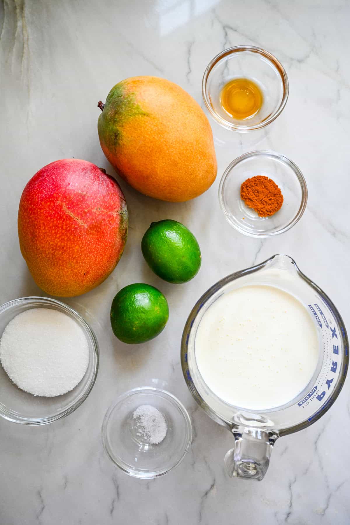 Ovanifrån av mango posset ingredienser.